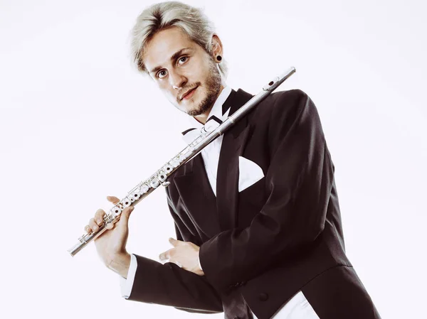 Male flutist wearing tailcoat holds flute — Stock Photo, Image