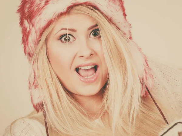 Shocked woman in winter furry hat — Stock Photo, Image