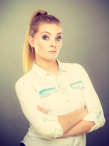 Angry woman looking very displeased standing with arms folded — Stock Photo, Image