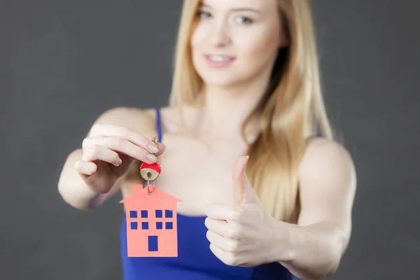 Woman holding key with house symbol — Stock Photo, Image