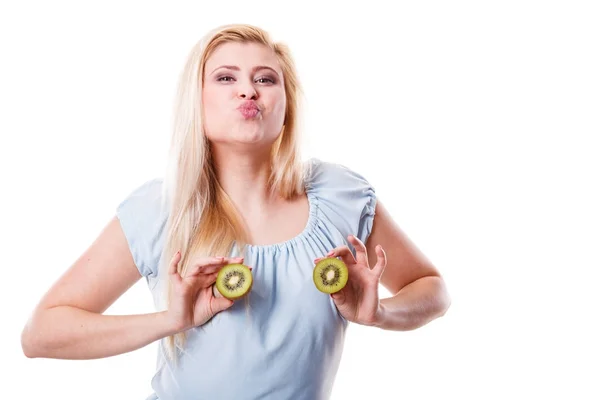 Woman holding green kiwi on breast — Stock Photo, Image