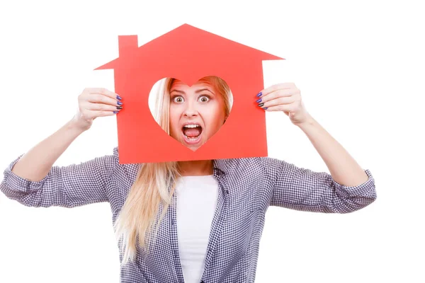 Funny girl holding red paper house with heart shape — Stock Photo, Image