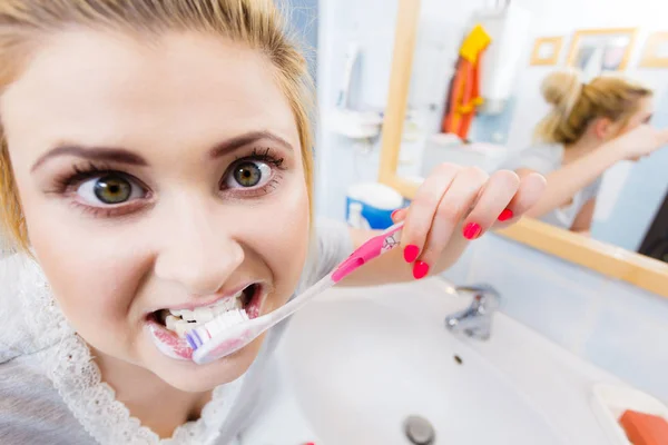 Woman brushing cleaning teeth in bathroom — Stock Photo, Image
