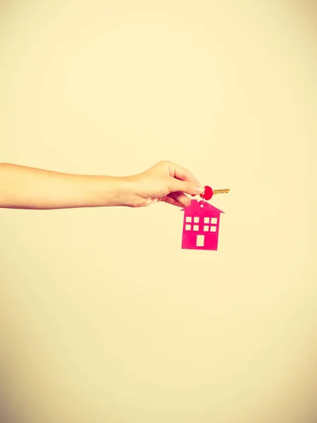 Person holding keys with pendant in house shape — Stock Photo, Image