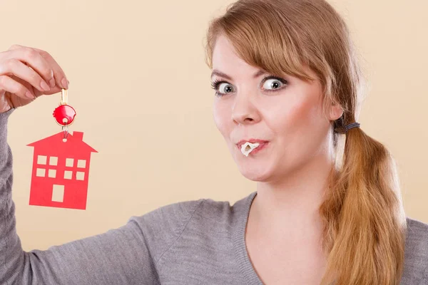 Mujer divertida tiene llaves de la casa comer goma de mascar — Foto de Stock