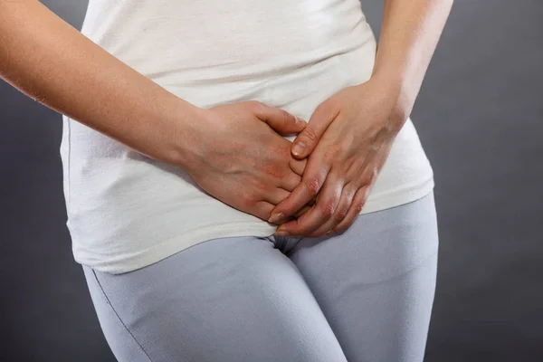 Woman with hands holding her crotch — Stock Image Woman with hands holding her crotch Stock Picture