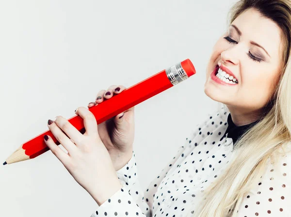 Funny woman holds big pencil in hand — Stock Photo, Image