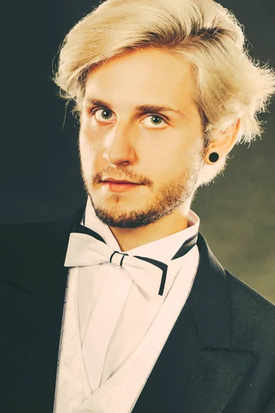 Handsome blonde man wearing dark tuxedo — Stock Photo, Image