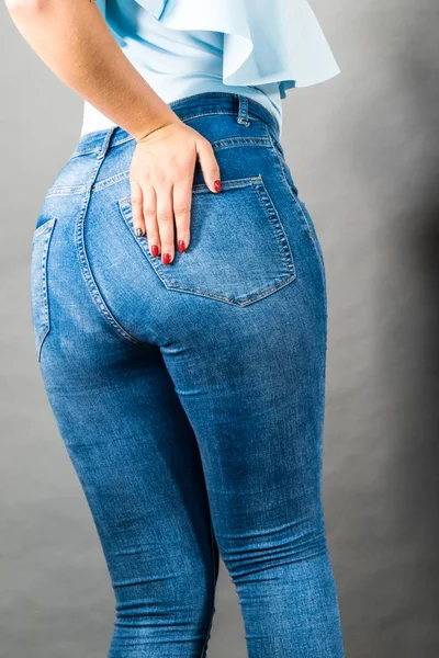 Woman hips buttocks in jeans clothing