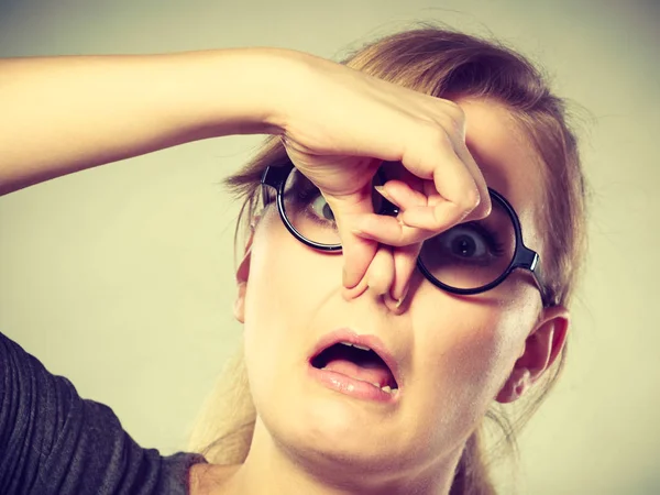 Girl pinches her nose because of stench stink. — Stock Photo, Image