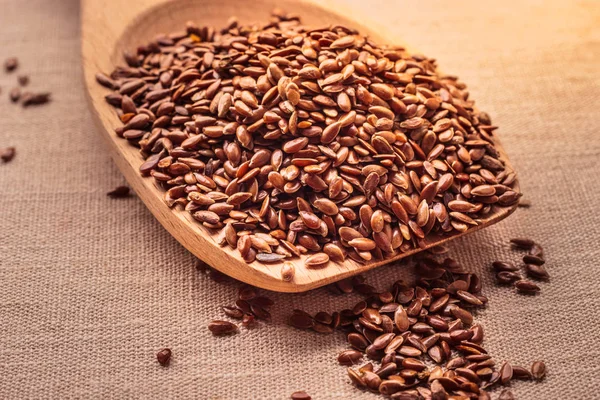 Flax seeds linseed on wooden spoon — Stock Photo, Image