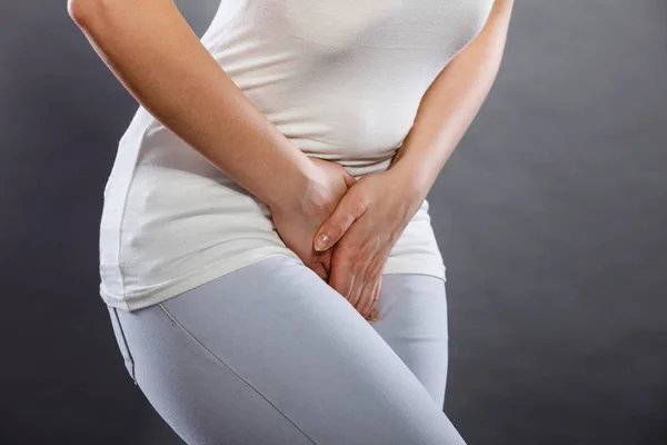 Woman with hands holding her crotch — Stock Image Woman with hands holding her crotch Royalty Free Stock Photos