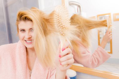 Saçları fırçalama sabahlık giyen kadın