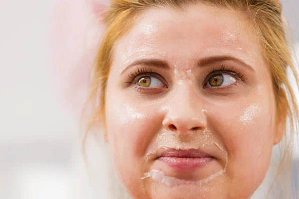 Happy young woman having gel mask on face — Stock Photo, Image