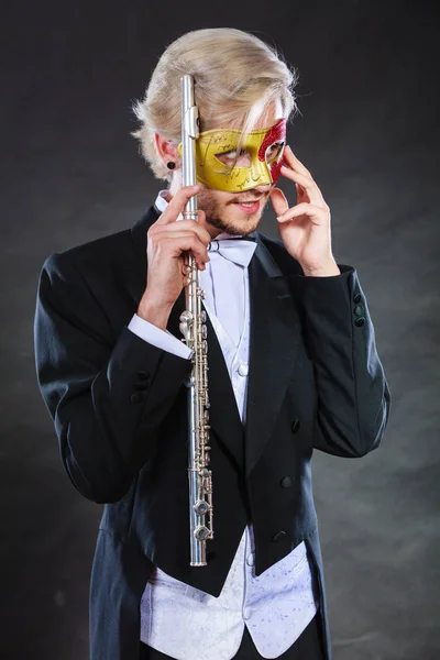 Man in carnival mask playing flute — Stock Photo, Image