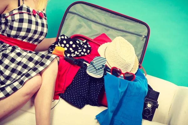 Woman choosing things to pack into suitcase — Stock Photo, Image