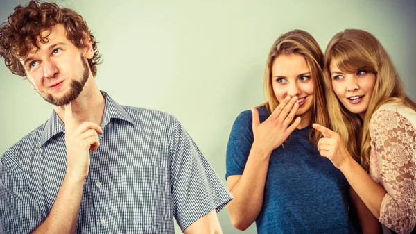 Two women talking gossiping about man. — Stock Photo, Image