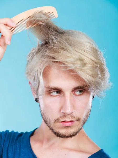 Man with stylish haircut combing his hair — Stock Photo, Image