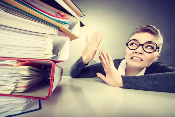 Accountant terrified of pils of binders. — Stock Photo, Image