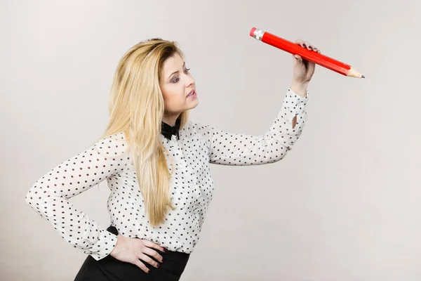 Positive woman holds big pencil in hand — Stock Photo, Image