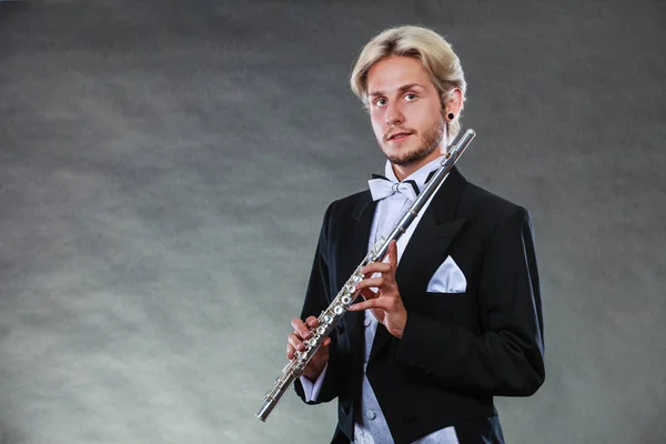 Elegantly dressed musician holding flute — Stock Photo, Image