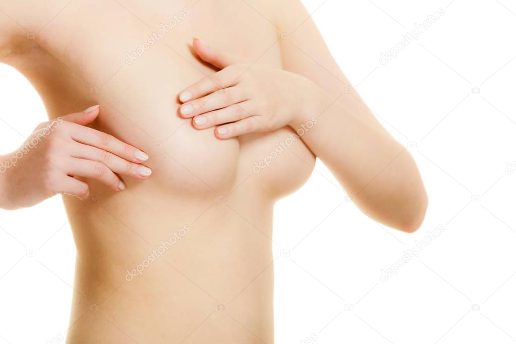 Woman examining her breasts for breast cancer
