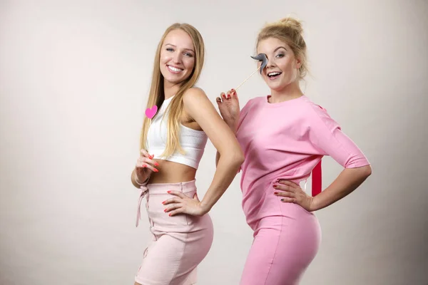 Two women holding carnival accessories — Stock Photo, Image