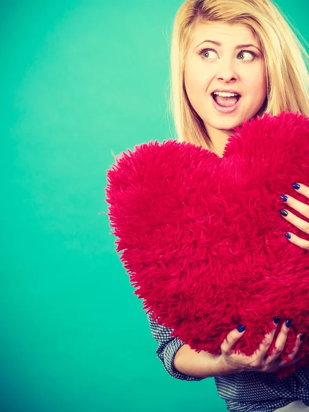 Mujer feliz sosteniendo almohada roja en forma de corazón — Foto de Stock