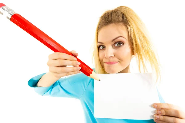 Woman with big pencil writing on paper — Stock Photo, Image