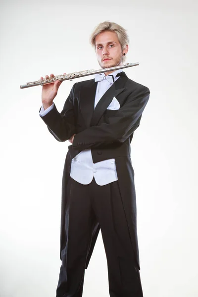 Male flutist wearing tailcoat holds flute — Stock Photo, Image