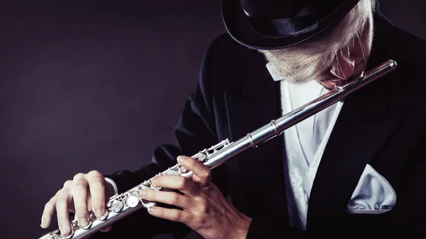 Elegantly dressed male musician playing flute — Stock Photo, Image