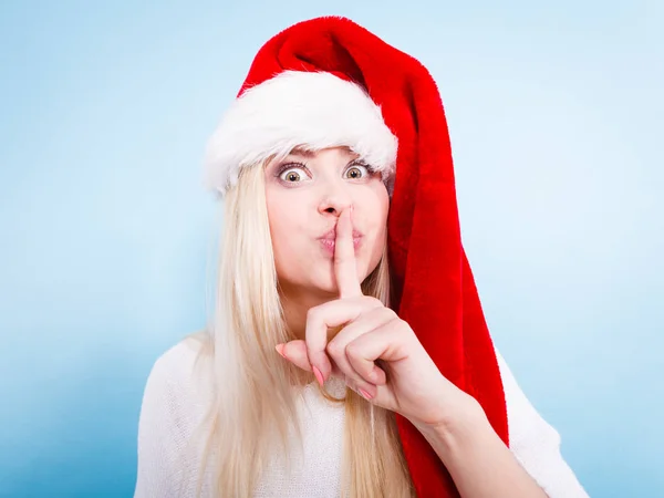 Woman wearing Santa Claus hat making faces — Stock Photo, Image