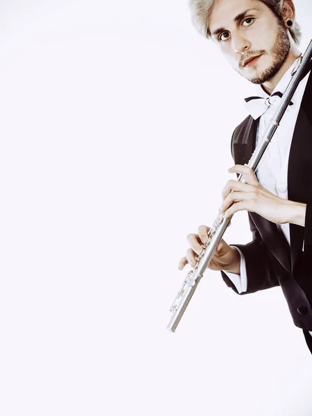 Male flutist wearing tailcoat holds flute — Stock Photo, Image