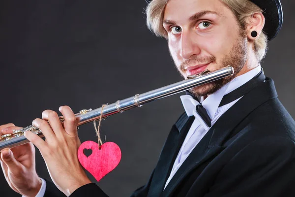 Male flutist with flute and heart. Love melody — Stock Photo, Image