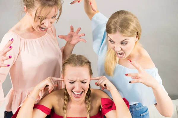 Woman being bullied by two females