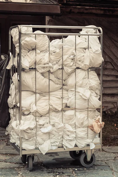 Big metal basket with hotel laundry — Stock Photo, Image