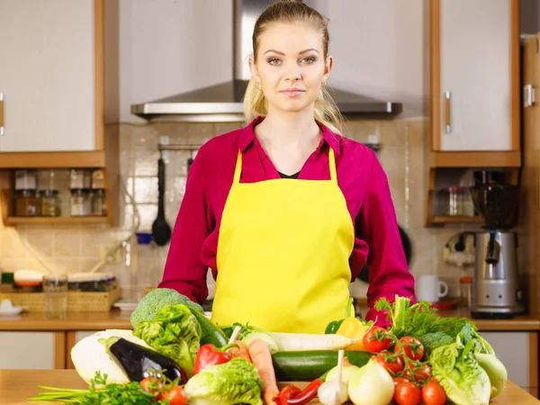 Woman in kitchen having many vegetables — Stock Photo, Image