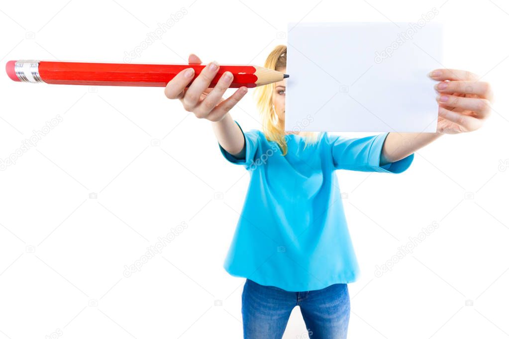 Woman with big pencil writing on paper