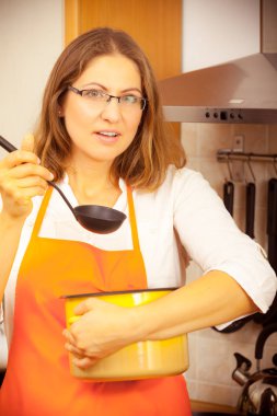 Kepçe ve mutfak tencereye kadın ile