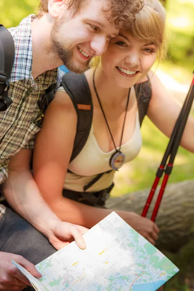 Excursionistas mochileros pareja lectura mapa en viaje . — Foto de Stock