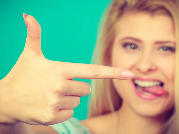 Happy blonde woman pointing with one finger — Stock Photo, Image