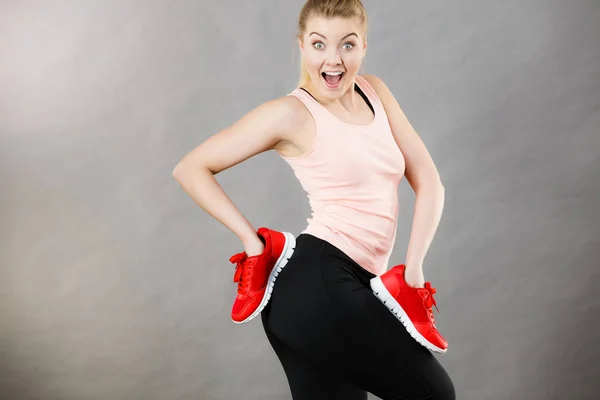 Mujer feliz presentando zapatillas deportivas zapatillas —  Fotos de Stock