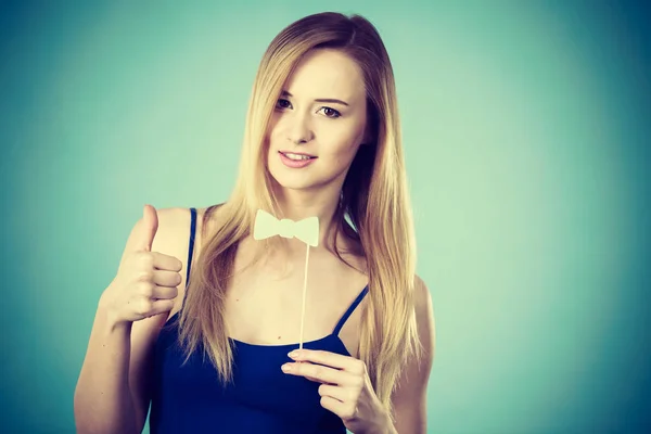 Woman holding carnival accessoies on stick — Stock Photo, Image