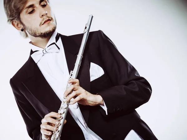 Male flutist wearing tailcoat holds flute — Stock Photo, Image