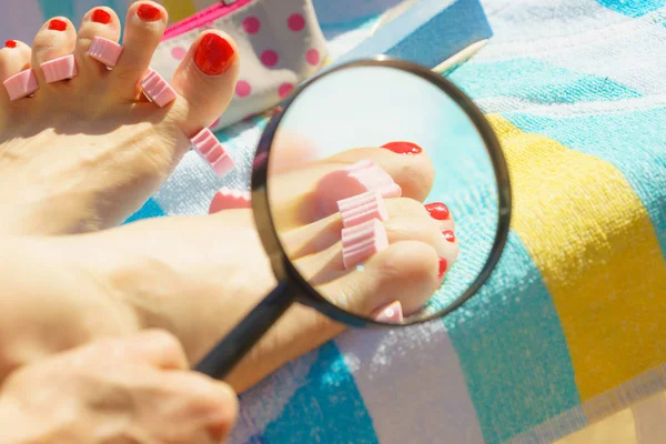 Woman magnifying pedicure