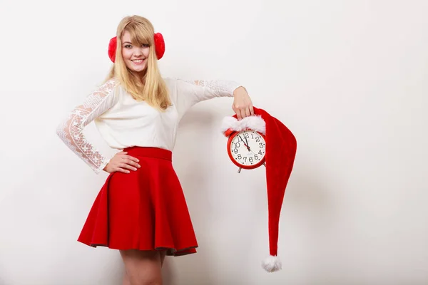 Happy woman with alarm clock. Christmas time.