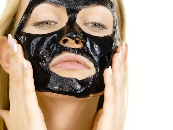 Girl with dried peel-off black mask on face — Stock Photo, Image