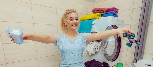 Girl wash laundry with different detergent.