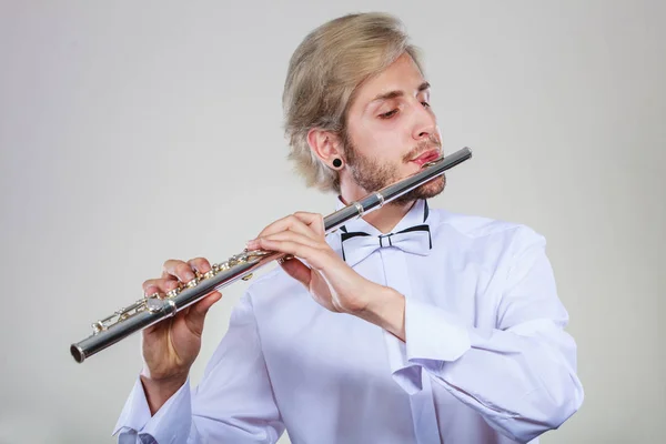 Male flutist playing his flute — Stock Photo, Image