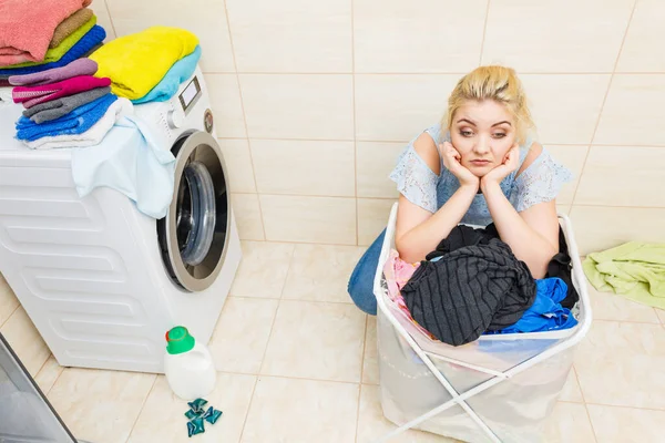 Unhappy girl with dirty clothes laundry. — Stock Photo, Image